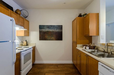 Kitchen witih wooden floors overhead storage and pantry space at Gateway Place in Atlanta, Georgia